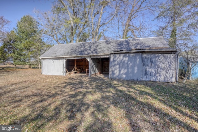 view of outbuilding featuring a lawn