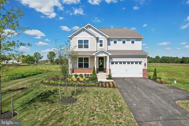 craftsman-style home featuring a garage and a front lawn