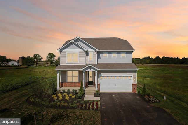 view of front of property featuring a lawn and a garage