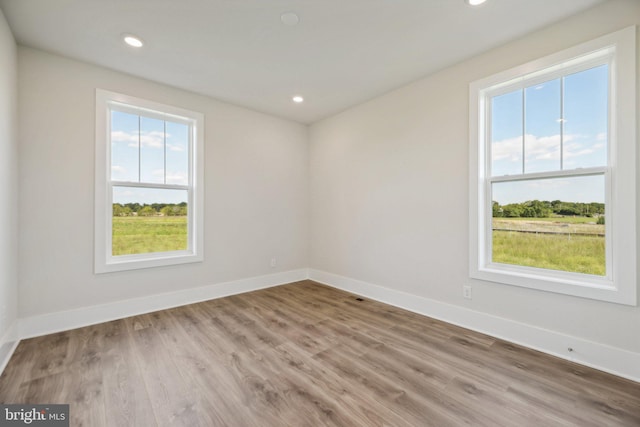 unfurnished room with light hardwood / wood-style floors