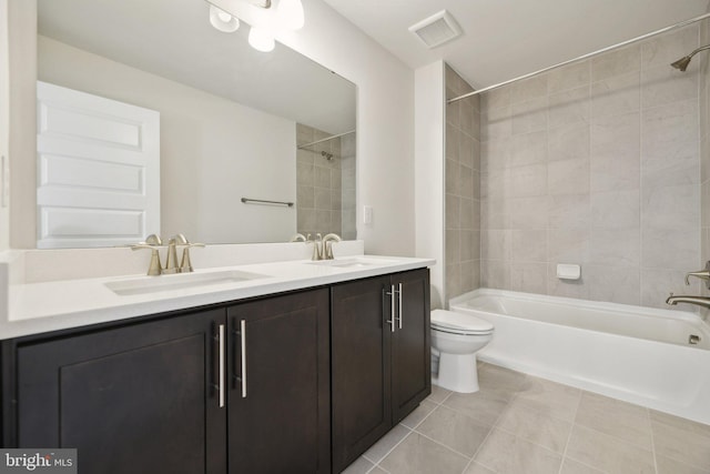 full bathroom featuring vanity, toilet, tile patterned floors, and tiled shower / bath