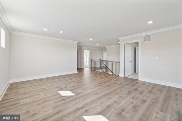 unfurnished living room featuring crown molding, light hardwood / wood-style flooring, and a wealth of natural light