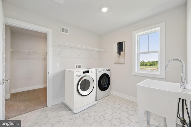 laundry room featuring sink and separate washer and dryer