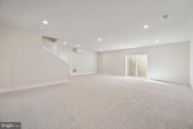 basement featuring light colored carpet