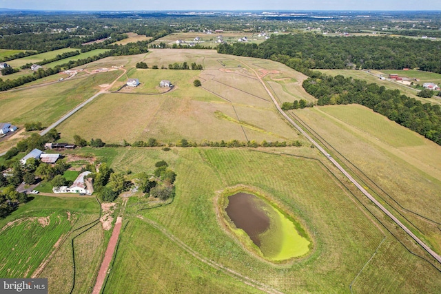 birds eye view of property featuring a rural view and a water view