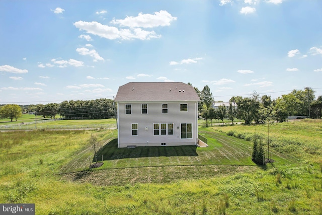 view of home's exterior with a lawn and a rural view