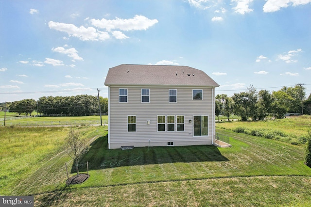 rear view of property with a lawn