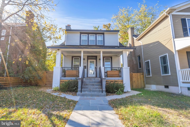 view of front of house featuring covered porch and a front lawn