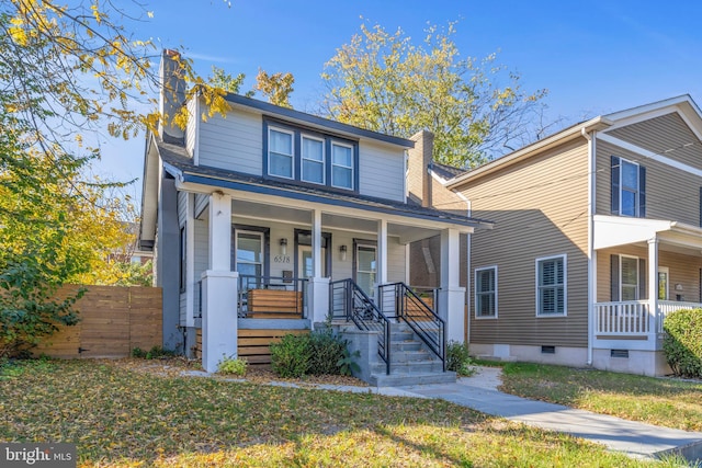view of front of house with covered porch, fence, and crawl space