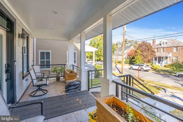wooden terrace with a porch