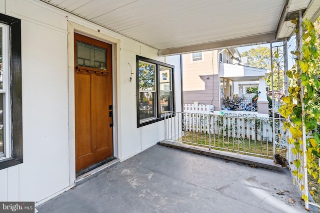 view of exterior entry with covered porch