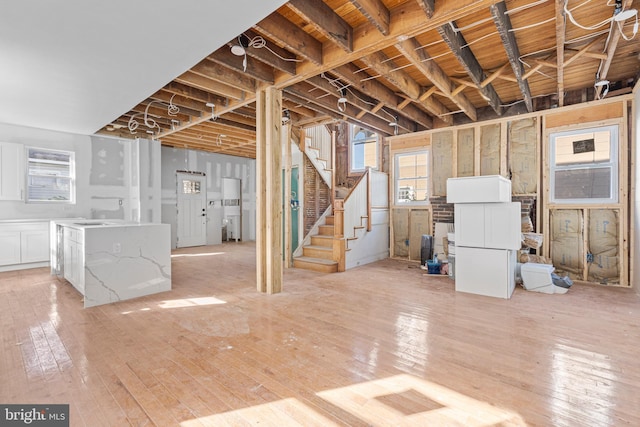 below grade area with light wood-style floors and stairs
