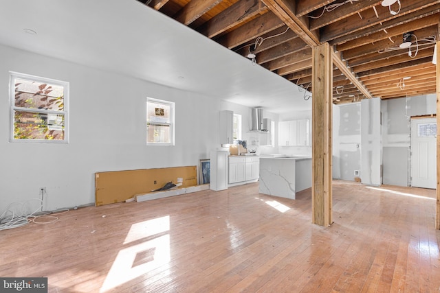 unfurnished living room featuring a wealth of natural light and light wood-style floors