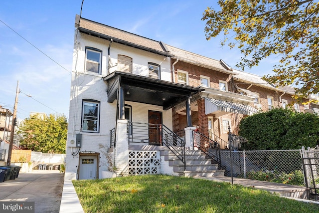 5317 9th St NW, Washington, DC 20011 - view of property featuring a porch, fence, and brick siding