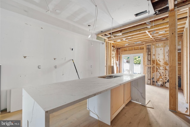 5317 9th St NW, Washington, DC 20011 - kitchen with a large island with sink, light brown cabinets, and light stone countertops