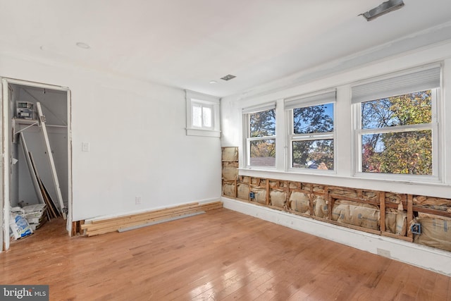 empty room with light hardwood / wood-style flooring