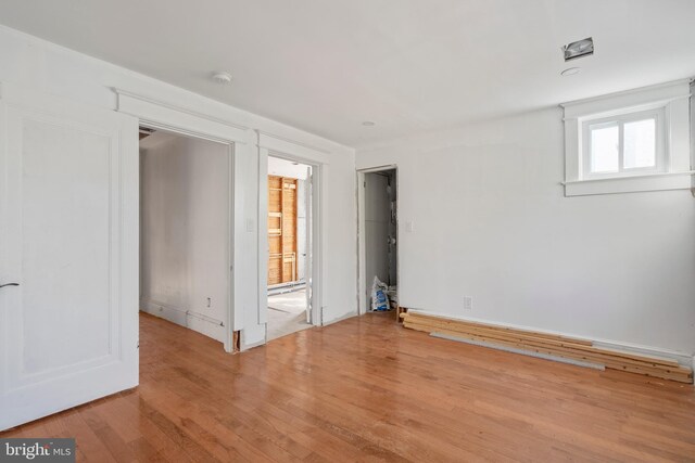 empty room with light hardwood / wood-style flooring