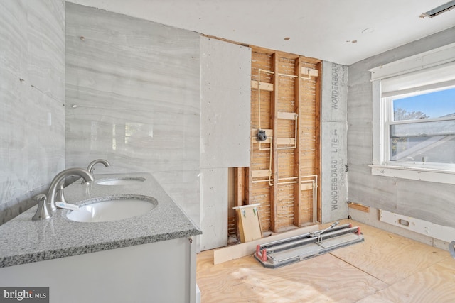 bathroom featuring double vanity and a sink