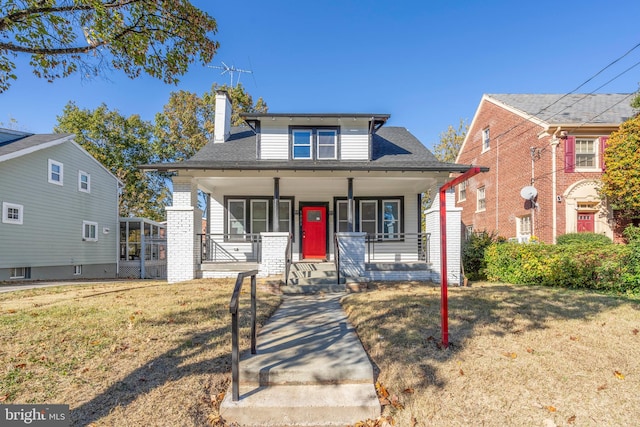 view of front facade with a front yard and a porch