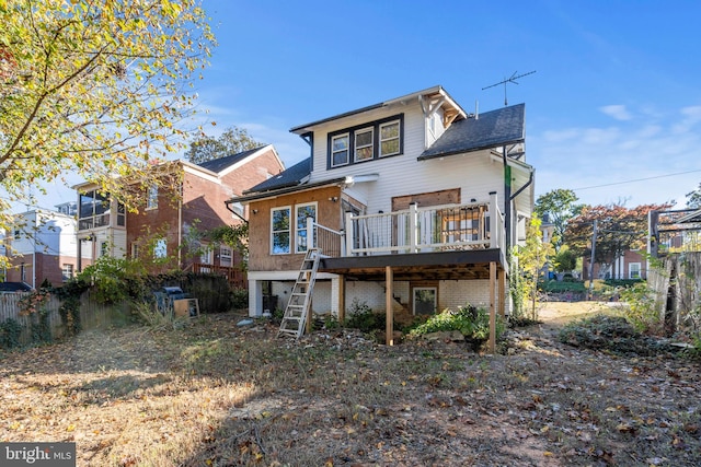 rear view of house with a wooden deck