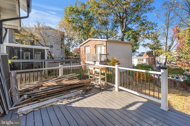 wooden deck with a sunroom
