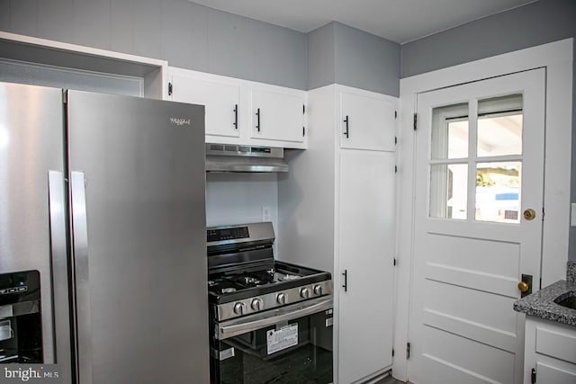 kitchen with stone counters, ventilation hood, appliances with stainless steel finishes, and white cabinets