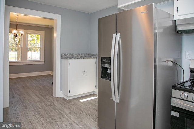 kitchen featuring white cabinetry, an inviting chandelier, stainless steel fridge, and light hardwood / wood-style floors