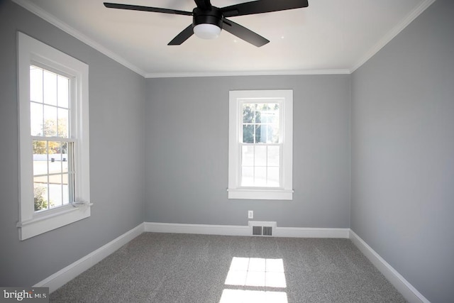 carpeted empty room with ornamental molding and ceiling fan