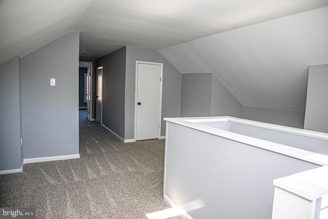 additional living space featuring lofted ceiling and carpet floors