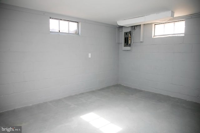 basement featuring electric panel and plenty of natural light