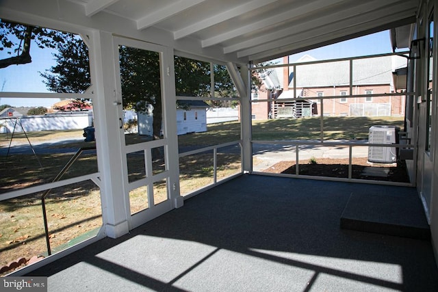 sunroom with vaulted ceiling with beams