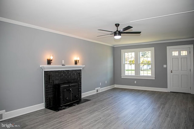 unfurnished living room with crown molding, dark hardwood / wood-style floors, a fireplace, and ceiling fan