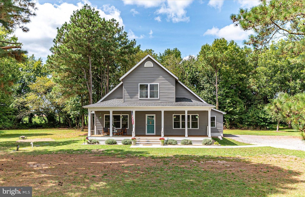 farmhouse inspired home featuring a front yard and a porch