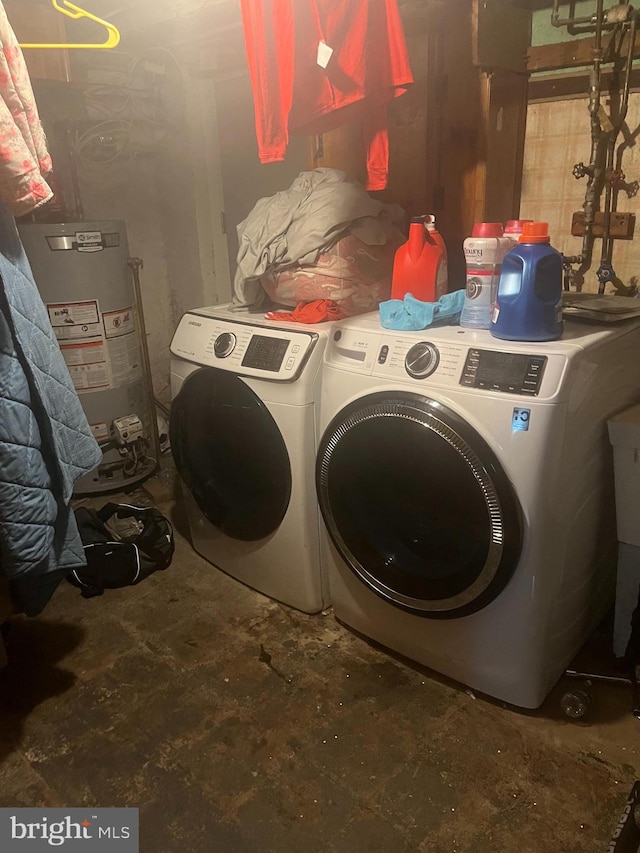 laundry room with water heater and separate washer and dryer