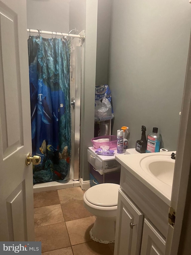 bathroom featuring vanity, toilet, tile patterned floors, and a shower with shower curtain