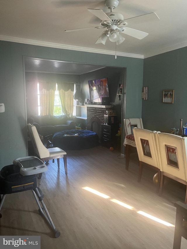 living room featuring ornamental molding, hardwood / wood-style flooring, and ceiling fan