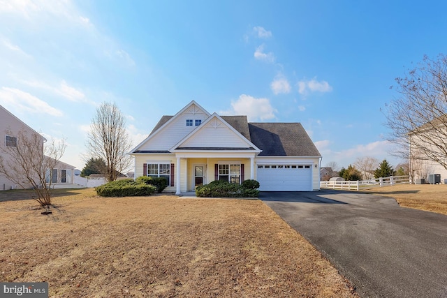 view of front of house with a porch, a garage, and a front yard