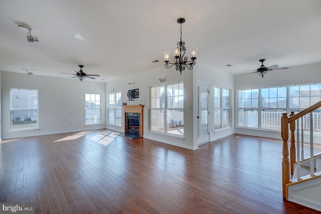 unfurnished living room featuring dark hardwood / wood-style flooring and ceiling fan