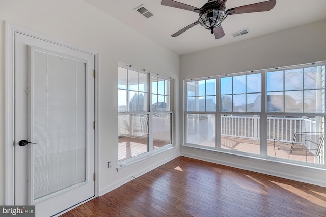 unfurnished sunroom featuring ceiling fan