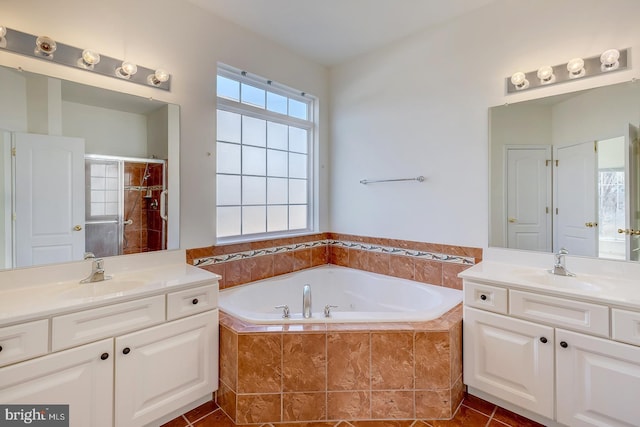 bathroom with tile patterned flooring, vanity, and plus walk in shower