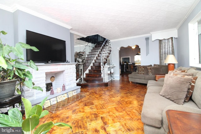 living room with crown molding, a textured ceiling, and a fireplace