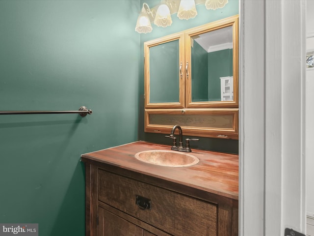 bathroom featuring vanity and ornamental molding