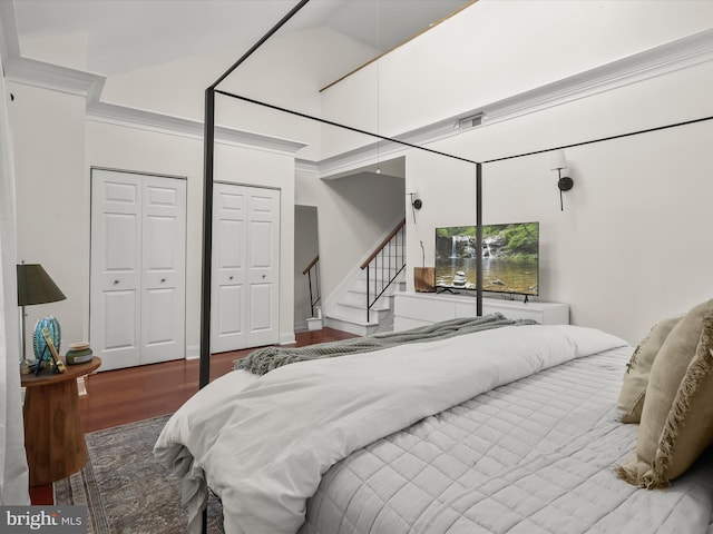 bedroom with lofted ceiling and hardwood / wood-style floors