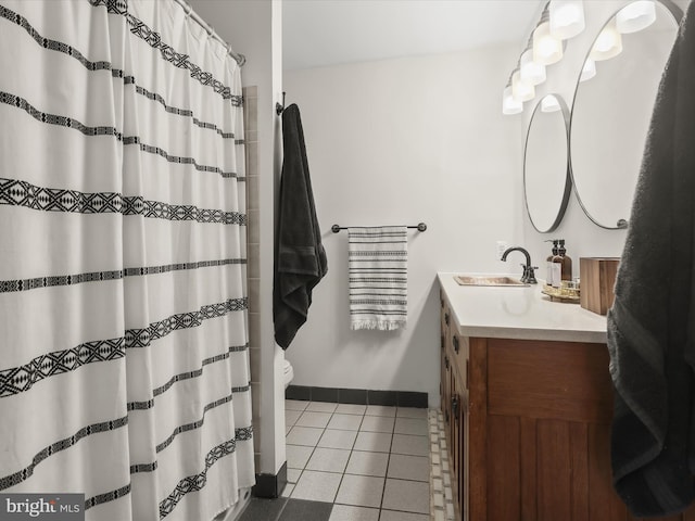 bathroom featuring tile patterned flooring, vanity, and toilet