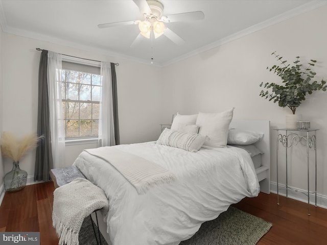 bedroom featuring dark hardwood / wood-style flooring, crown molding, and ceiling fan