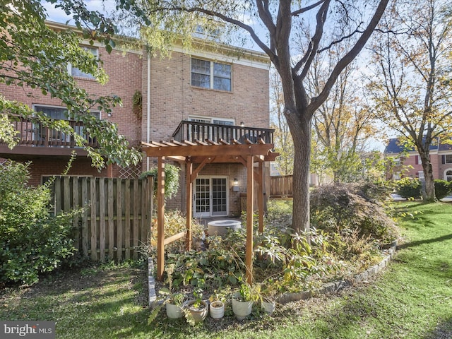 back of property with a yard and a pergola