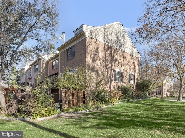 view of side of home with a lawn