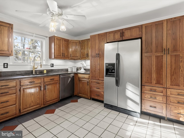 kitchen featuring appliances with stainless steel finishes, sink, ornamental molding, light tile patterned floors, and ceiling fan