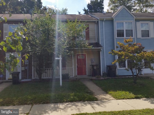 view of property featuring a front lawn