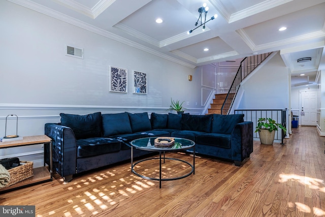 living room with ornamental molding, beamed ceiling, hardwood / wood-style flooring, and coffered ceiling